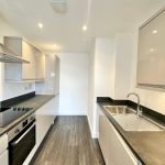Modern kitchen with sleek cabinets and appliances.