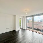 Bright empty room with large window views.
