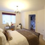 Elegant bedroom with ensuite and modern decor.