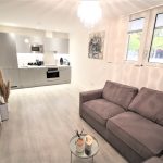 Modern open-plan kitchen and living room space.