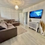 Modern living room with sofa and TV.