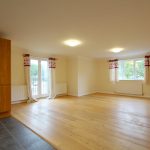 Spacious, bright living room with wooden flooring.