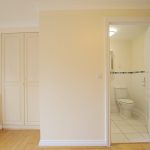 Empty room with open door to bathroom.
