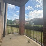 Brick patio overlooking garden and sky