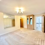 Spacious bedroom with wardrobe and ensuite bathroom.