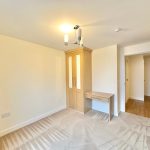 Empty bedroom with wardrobe and desk