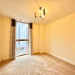 Empty room with window and beige carpet