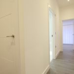 Modern hallway with multiple white doors