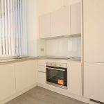 Modern kitchen with white cabinets and oven