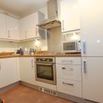 Modern kitchen with white cabinets and appliances