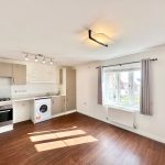 Modern kitchen with appliances and large window.