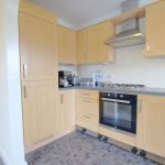 Modern kitchen with wooden cabinets and appliances