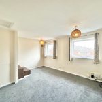 Bright empty room with carpet and windows.