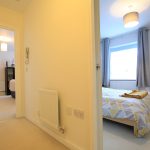 Bright bedroom with modern decor and window view.