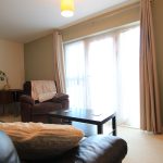 Cosy living room with chair, sofa, and table.