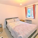 Modern bedroom with double bed and window