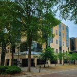 Modern building surrounded by trees on campus