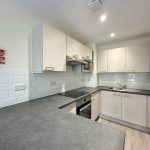 Modern kitchen with appliances and fire safety equipment.