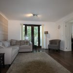 Modern living room with corner sofa and armchair.