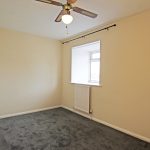 Empty room with window and ceiling fan