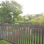 Garden with trees and a wooden fence