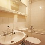 Small bathroom with sink, toilet, and bathtub.