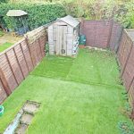 Back garden with shed and patio furniture.