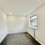 Empty room with white walls and window.