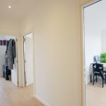 Bright hallway leading to furnished room