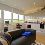 Modern kitchen and home office space with sofa