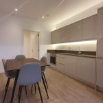 Modern kitchen with dining table and chairs.
