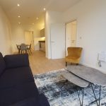 Modern living room with dining area and kitchenette.