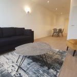 Modern living room with sofa and dining table.