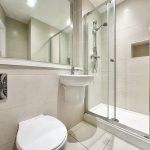 Modern bathroom with shower and toilet.