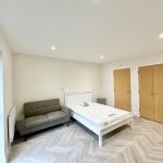 Modern bedroom with sofa and wardrobe