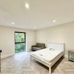 Modern, minimalist bedroom with large window view.