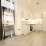 Modern kitchen with large windows and wooden floor