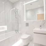 Modern white bathroom with bathtub and sink
