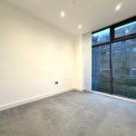 Empty room with large window overlooking garden