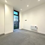 Empty room with carpet and window.