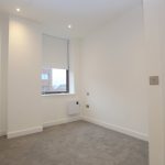 Empty white room with grey carpet and window