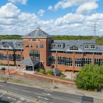 Red brick office building with large windows.