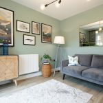 Modern living room with grey sofa and wall art.