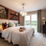 Modern bedroom with large window and artwork.