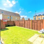 Sunny garden with basketball hoop and shed