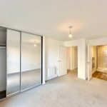 Spacious bedroom with wardrobe and ensuite bathroom.