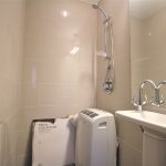 Modern bathroom with shower and compact heater