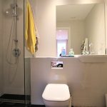 Modern bathroom with shower, sink, and toilet.
