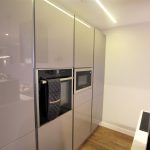 Modern kitchen with oven and microwave.
