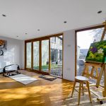 Bright art studio with paintings on easels.